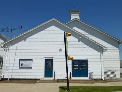 Front of church, July 2014. Doors painted different color, and crucifix removed.