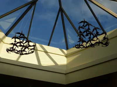 Bird sculptures suspended from ceiling.
