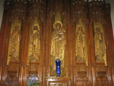 According to parish history: Statues of King David, Archangel Gabriel, Mary, Archangel Raphael, St. Joachim. The carving on Mary's left hand is unfinished.
