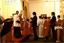 People receiving Communuion in the church before redecoration. Source: Our Lady of Good Counsel Web site (defunct)