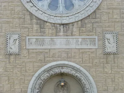 Inscription above main entrance and reliefs.