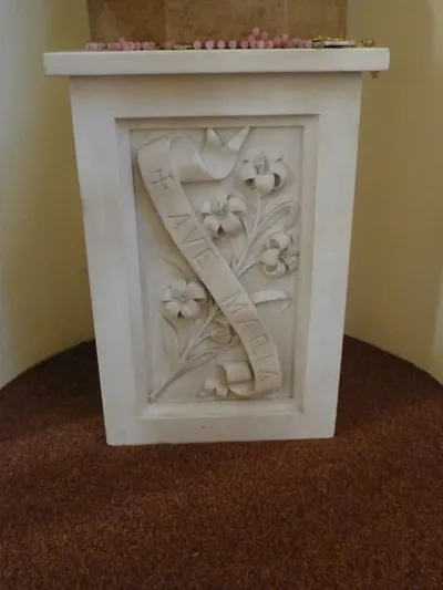 Pedestal below Our Lady statue.