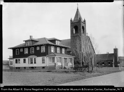 Photograph of present church next to the original church turned school. Source: Albert R. Stone negative collection