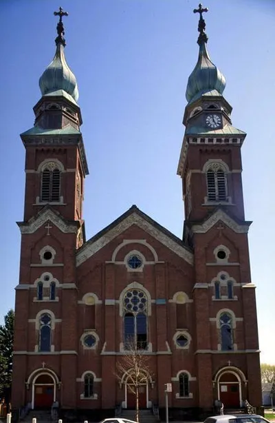 Photograph taken in front of the church, 1980s. Some vandalism to the stained glass windows. Source: Rochester Public Library.