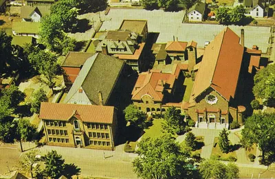 Postcard with aerial view of Holy Rosary campus, 1960s. Former school/church on left.