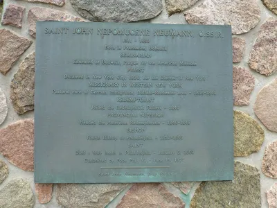 Plaque next to St. John Neumann relief.
