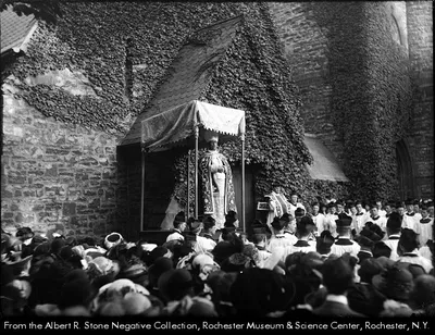 Bishop Hickey preaches outside of the chapel. Source: Albert R. Stone negative collection