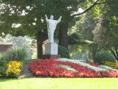 Statue of Christ at Dewey Ave entrance, seen from angle.