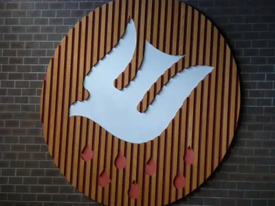 Holy Spirit woodwork behind altar.