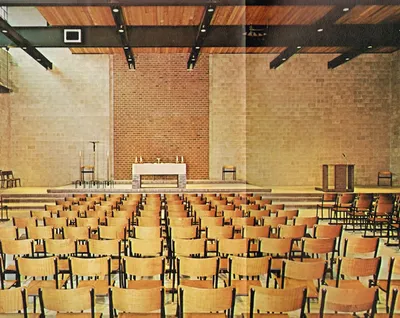 Plain interior with cement walls and chairs. Source: Holy Spirit Church (1969 parish history book)