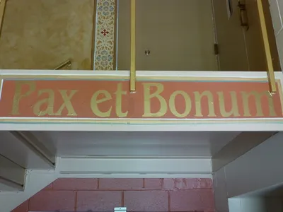 Latin text painted on stairwell of the side entrance.