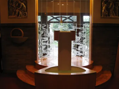 Baptismal font and sand-blasted glass.
