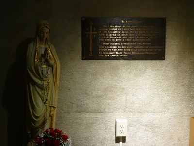 Statue of Our Lady and memorial plaque.