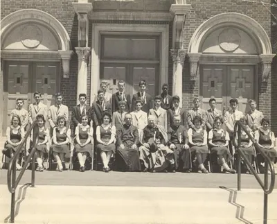 Class of 1959 on front steps of church. Compare with previous image and note the change to the present-day style of doors.