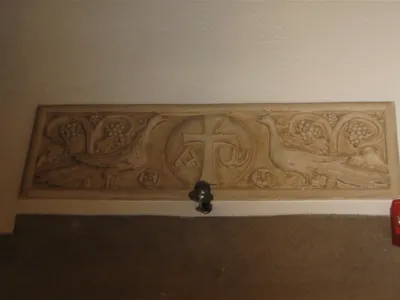 Engraving above left and right entrances.