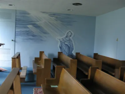 Pews in the chapel instead of chairs.