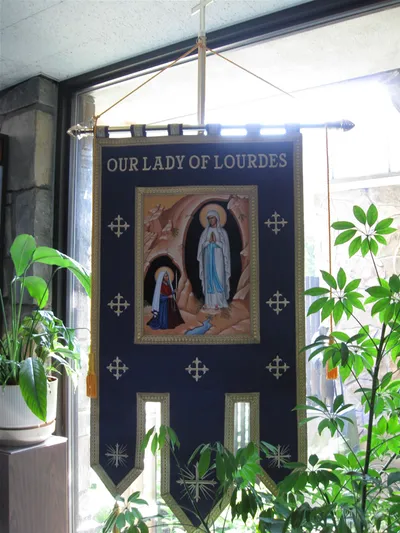 Our Lady of Lourdes banner.