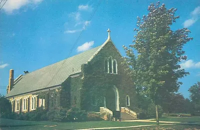 Old postcard of church exterior. Note the ivy along the front and sides.