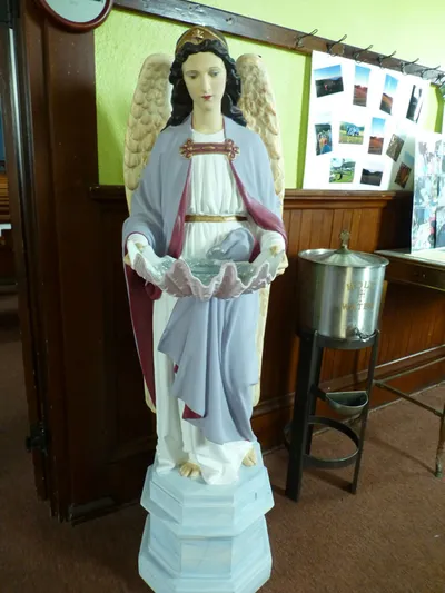 Angel statue and holy water font.