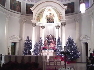 Sanctuary decorated for Christmas. Nativity set above tabernacle.