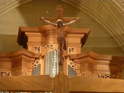 Crucifix atop wood beam.