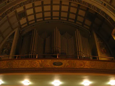 Large pipe organ in choir loft.