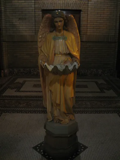 Angel holy water font in narthex.