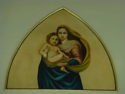 Painting of Our Lady with Christ child on the choir loft wall.