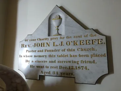 Memorial plaque recognizing founding pastor.