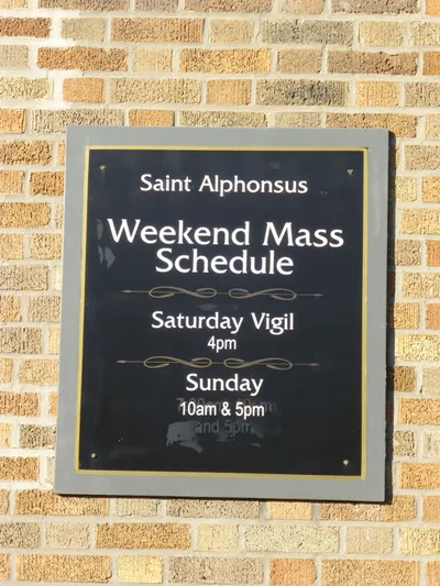 Mass schedule sign.