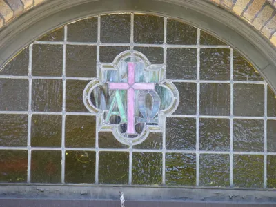 Stained glass above school entrance.