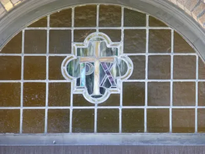 Stained glass above school entrance.