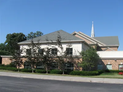 Behind the church.