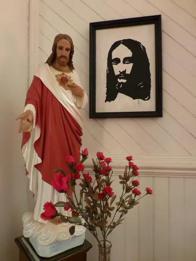 Sacred heart statue and a painting.