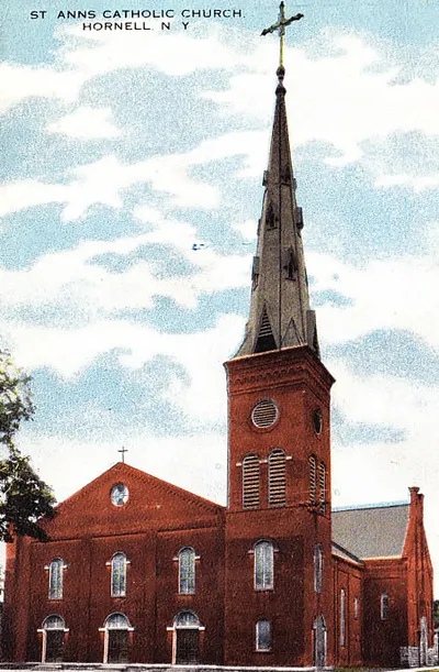 Old postcard of exterior. Note the very large cross on the steeple.