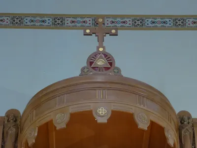 Cross atop reredo.