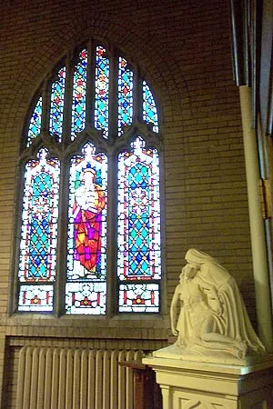 Pieta next to stained glass window. Source: Rochester Pluralism Project (defunct)