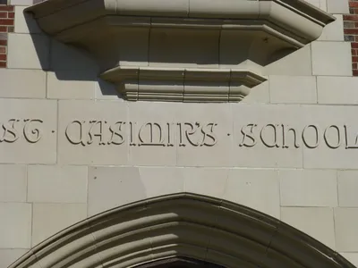 Inscription above entrance to school.