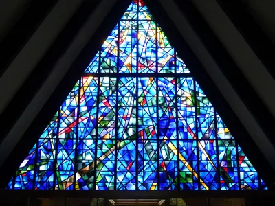 Large stained glass window above front entrance.