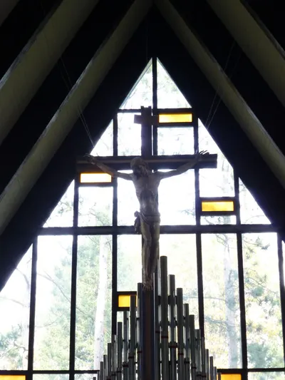 Crucifix suspended over sanctuary.
