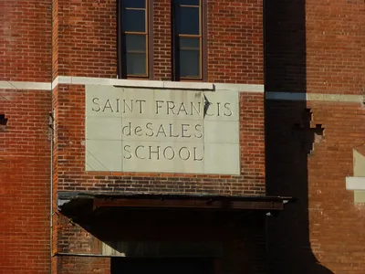 Inscription above entrance to school.