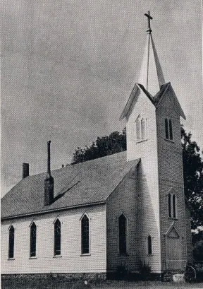 Exterior of church, 1939. The steeple was removed and the front modified in a later renovation. The chimney on the left side is also gone. Source: Catholic Courier Golden Jubilee Edition: 1889-1939