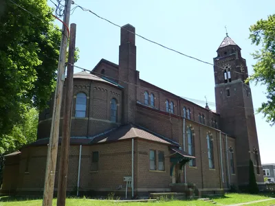 View from the back. The stained glass windows of saints above the altar have been removed.
