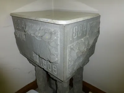 A cornerstone-shaped Baptismal font? Not sure.