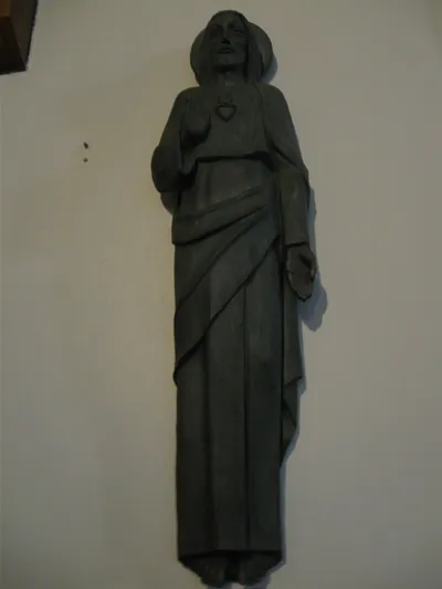 Wall-mounted sacred heart statue.