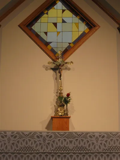 Crucifix on podium behind the altar.