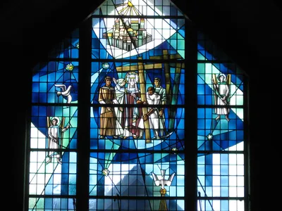 Large stained glass window above main entrance.