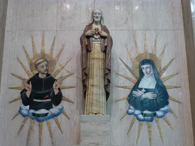 Sacred heart statue and two images.