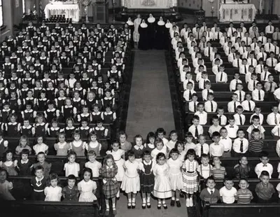 School children posing for picture inside of church, 1957. Source: East Rochester Municipal Historian Collection