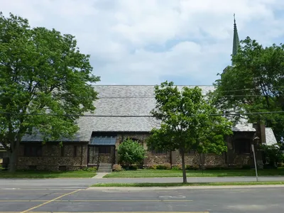 Church seen from left side parking lot across the street.